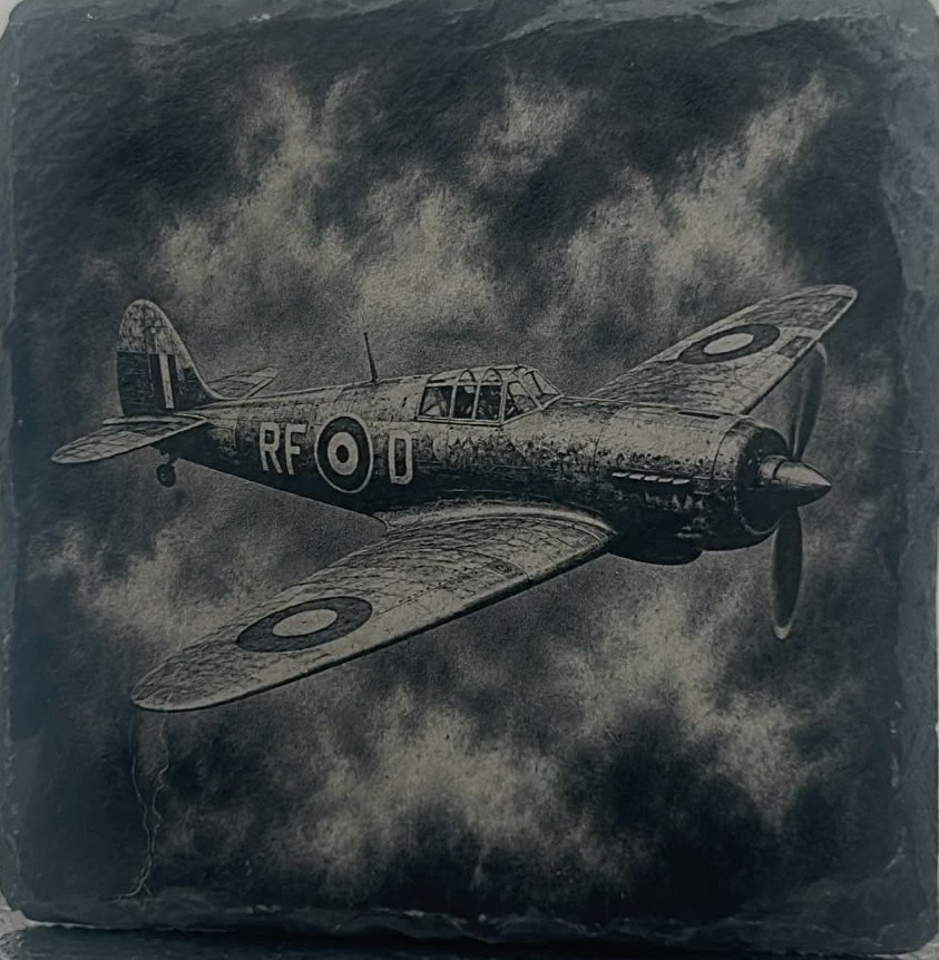 Single propeller aircraft engraved on slate